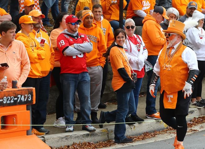 Georgia fan Matthew Winn finds himself outnumbered by a host of Tennessee fans arriving at Neyland Stadium for a NCAA college football game on Saturday, Nov. 18, 2023, in Knoxville.  Curtis Compton for the Atlanta Journal Constitution