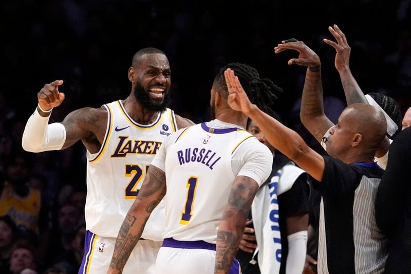 Los Angeles Lakers forward LeBron James, left, complains about a foul call against him as guard D'Angelo Russell looks on during the second half in Game 4 of an NBA basketball first-round playoff series against the Denver Nuggets Saturday, April 27, 2024, in Los Angeles. (AP Photo/Mark J. Terrill)