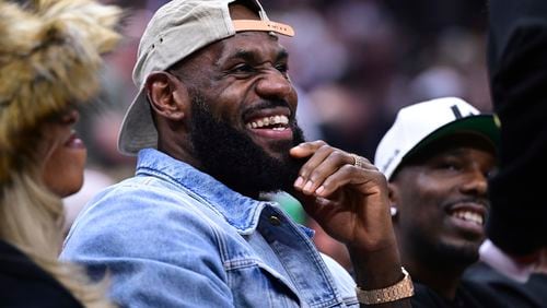 Los Angeles Lakers forward LeBron James smiles during the first half of Game 4 of an NBA basketball second-round playoff series between the Cleveland Cavaliers and Boston Celtics, Monday, May 11, 2024, in Cleveland. (AP Photo/David Dermer)