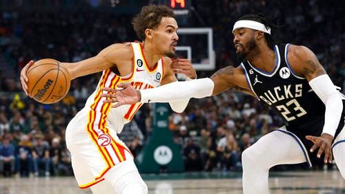 Atlanta Hawks guard Trae Young (11) drives against Milwaukee Bucks' Wesley Matthews (23) during the first half of an NBA basketball game, Saturday, Oct. 29, 2022, in Milwaukee. (AP Photo/Jeffrey Phelps)