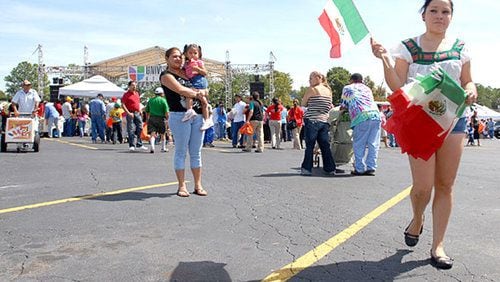 Susana Olague sells Mexican flags during the celebration at Plaza Fiesta.