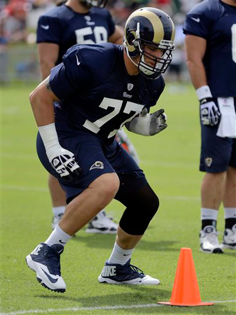 St. Louis Rams tackle Jake Long takes part in a drill at NFL football training camp Thursday, July 25, 2013, at the team's training facility in St. Louis. (AP Photo/Jeff Roberson)