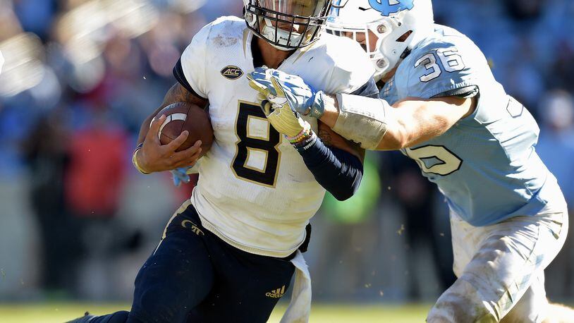 CHAPEL HILL, NC - NOVEMBER 03:  Cole Holcomb #36 of the North Carolina Tar Heels tackles Tobias Oliver #8 of the Georgia Tech Yellow Jackets during the second half of their game at Kenan Stadium on November 3, 2018 in Chapel Hill, North Carolina. Georgia Tech won 38-28.  (Photo by Grant Halverson/Getty Images)