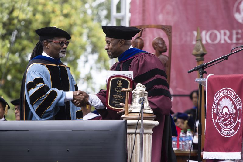 Morehouse College Provost Kendrick T. Brown (left) presents an award to Morehouse College professor Lance Shipman Young (right) during the Morehouse College commencement ceremony on Sunday, May 21, 2023 on Century Campus in Atlanta. CHRISTINA MATACOTTA FOR THE ATLANTA JOURNAL-CONSTITUTION
