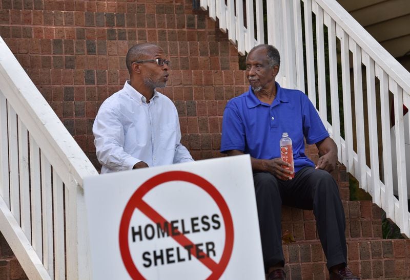 In this August 2016 photo, Devon Holloway (left) and former state Rep. Douglas Dean talk outside Holloway’s home in the Pittsburgh neighborhood of Atlanta. Holloway co-founded PittsburghAtl Homeowners United, a group of relatively new Pittsburgh residents. Dean headed the Pittsburgh Neighborhood Association of mostly longtime residents. HYOSUB SHIN / HSHIN@AJC.COM