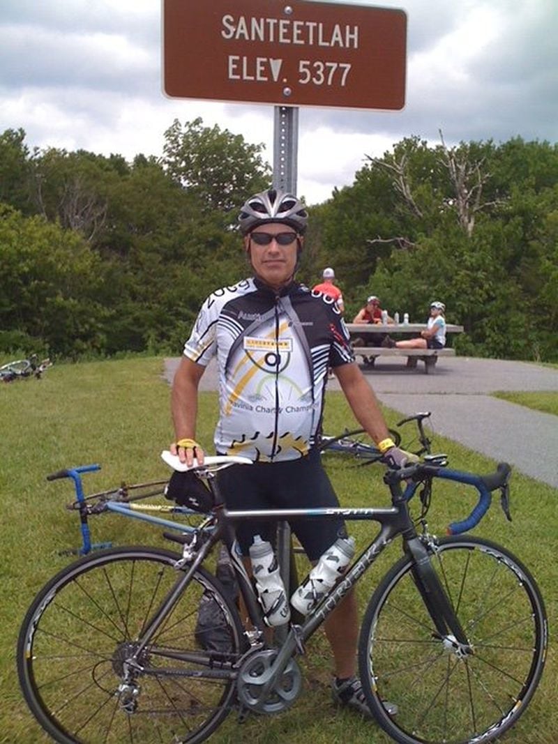After undergoing heart surgery in 2000, Il Giallo chef-owner Jamie Adams took up cycling. “It’s a way to clear your head,” Adams said. “It’s just you, the bike and the road.” Here, Adams poses after summiting a 27-mile climb in Santeetlah, N.C. CONTRIBUTED
