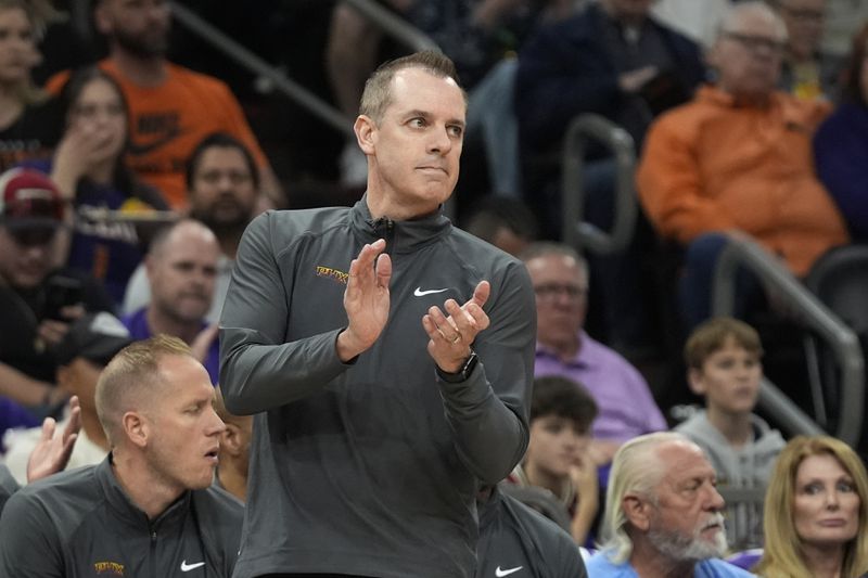 Phoenix Suns head coach Frank Vogel applauds his players during the first half of Game 4 of an NBA basketball first-round playoff series against the Minnesota Timberwolves, Sunday, April 28, 2024, in Phoenix. (AP Photo/Ross D. Franklin)