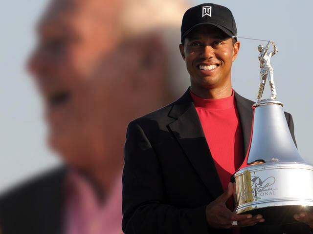 Tiger Woods holds the Arnold Palmer Invitational golf tournament trophy, Orlando, Florida in March of 2008.