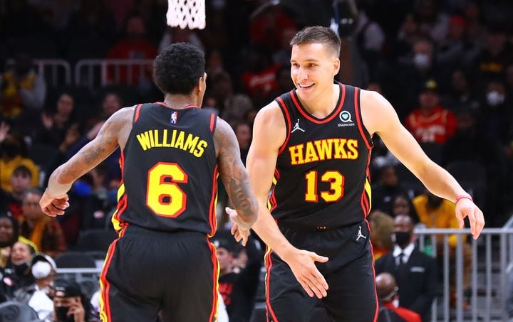 Hawks guard Bogdan Bogdanovic gets five and a chest bump from Lou Williams after hitting a three against the Sacramento Kings for 3 of his 16 points during the first half in a NBA basketball game on Wednesday, Jan. 26, 2022, in Atlanta. The Hawks won 121-104. “Curtis Compton / Curtis.Compton@ajc.com”`