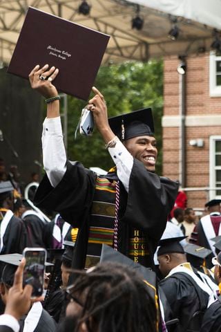 Roland Moses Bland proudly brandishes his degree during the Morehouse College commencement ceremony on Sunday, May 21, 2023, on Century Campus in Atlanta. The graduation marked Morehouse College's 139th commencement program. CHRISTINA MATACOTTA FOR THE ATLANTA JOURNAL-CONSTITUTION