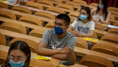 Students wearing face masks sit at their desks keeping social distance, ahead of a selectivity exam on Tuesday, July 7, 2020 in Sabadell, outside Barcelona, Spain.