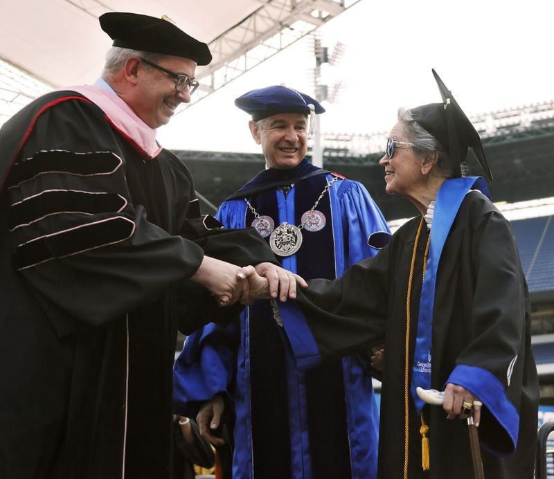 Joyce Lowenstein, 93, is congratulated by Georgia State President Mark Becker (center) and College of the Arts Dean Wade Weast after she received her bachelor’s degree Thursday from Georgia State University in Atlanta. She started taking classes there in 2012. Her degree is in art history. BOB ANDRES / BANDRES@AJC.COM