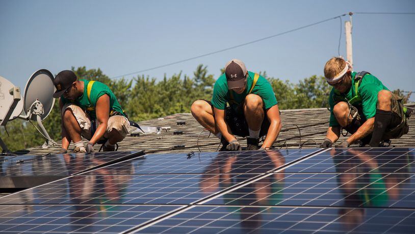 Solar panels, which are appearing in more places around the U.S., are likely to become a much more common sight on Atlanta homes in the next few years. (Here, they’re being installed on the roof of a home in Kendall Park, N.J.) MICHAEL NAGLE / BLOOMBERG 2015