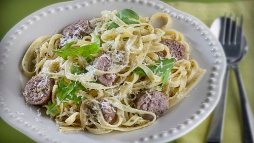 A freshly made tapenade, with green olives, garlic, anchovy, capers and lemon zest, grounds this linguine dish bolstered with Italian sausage and finished with fresh arugula. (Bill Hogan/Chicago Tribune/TNS)