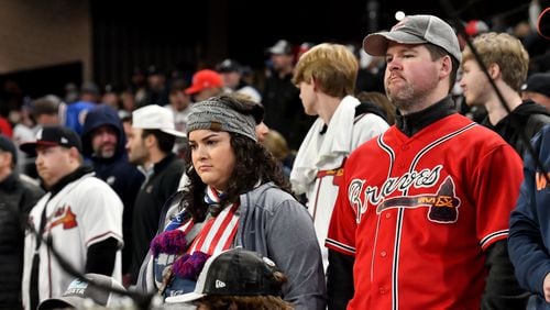 Braves fans react during the top of the ninth inning as the Braves were down 9-5 to the Houston Astros in game 5 of the World Series at Truist Park, Sunday, October 31, 2021, in Atlanta. Hyosub Shin / Hyosub.Shin@ajc.com