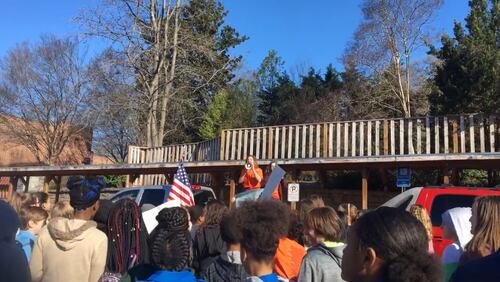 Inman Middle School students are led in a cheer of "Protect our schools, not the guns" by Malori Switzer, an eighth-grade student who helped organize the walkout.
