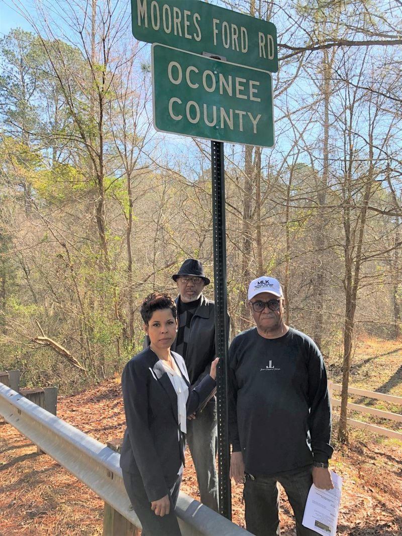 Former state Rep. Tyrone Brooks (right) poses with Dana Young Levett and the Rev. Ron Brown near where George and Mae Dorsey and Roger and Dorothy Malcom were lynched in 1946. Levett’s grandfather Dan Young buried the victims. GRACIE BONDS STAPLES / GSTAPLES@AJC.COM
