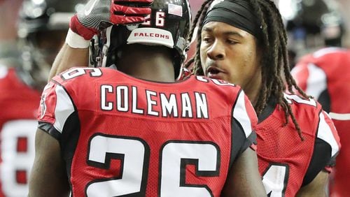 Falcons running back Tevin Coleman gets a pat on the helmet from running back Devonta Freeman after he scored a touchdown against the Cardinals for a 24-13 lead during the third quarter in an NFL football game on Sunday, Nov. 27, 2016, in Atlanta. The pair combined for three touchdowns, two by Freeman. Curtis Compton/ccompton@ajc.com