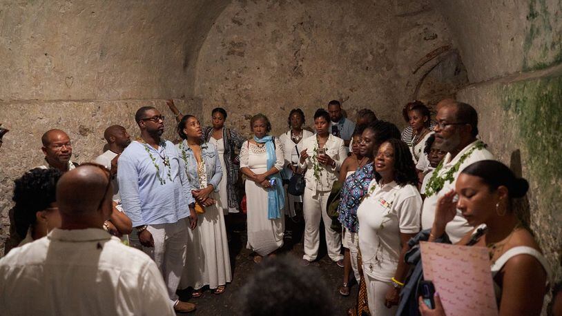 Debra Santos (blue scarf), an Atlanta Airbnb host, who is visiting Ghana as part of that nation’s “Year of the Return.” African Americans have been encouraged to return to Africa this year to mark 400 years of slavery. “My face says it all,” Santos said of the photograph, taken in an Elmina Castle dungeon where dozens of female captives would have been held before departing into slavery.