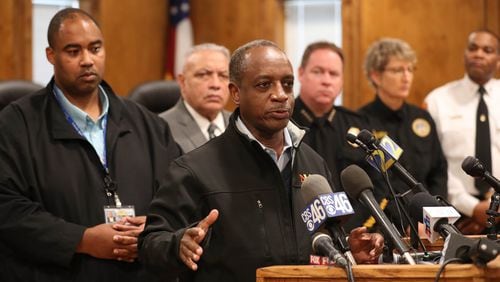 DeKalb County CEO Michael Thurmond speaks during a press conference to discuss the water main break on Buford Highway at the Doraville City Council Chambers Wednesday, March 7, 2018, in Doraville. Reginald Wells, left, was at the time acting director of watershed management. PHOTO / JASON GETZ