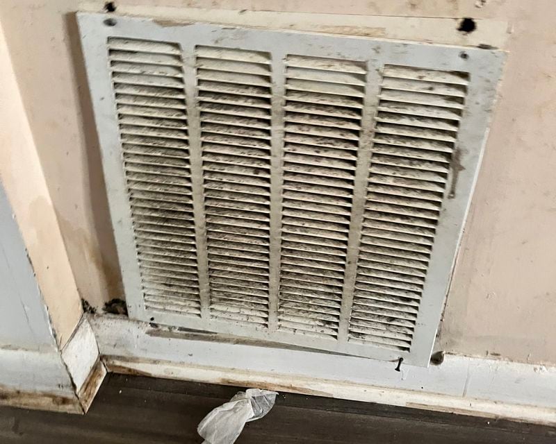 After a pipe burst and the air conditioning broke in Louana Joseph’s apartment, gray and black splotches that she believes were mold covered a ventilation grille. (Andy Miller/KHN)