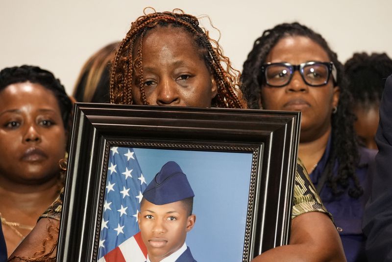Chantemekki Fortson, mother of Roger Fortson, a U.S. Navy airman, holds a photo of her son during a news conference regarding his death, along with family and Attorney Ben Crump, Thursday, May 9, 2024, in Ft. Walton Beach, Fla. Fortson was shot and killed by police in his apartment on May 3, 2024. (AP Photo/Gerald Herbert)