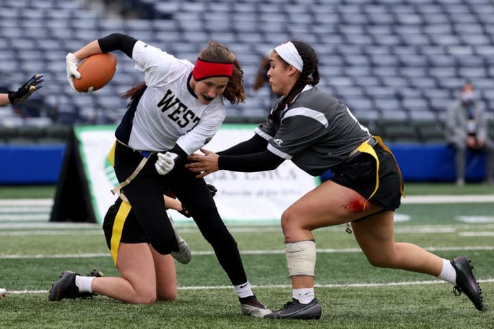 West Forsyth defensive back Haylee Dornan (1) is tackled by Hillgrove's Kaylan Sacus (21) after Dornan made an interception during the Class 6A-7A Flag Football championship at Center Parc Stadium Monday, December 28, 2020 in Atlanta, Ga.. JASON GETZ FOR THE ATLANTA JOURNAL-CONSTITUTION