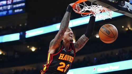 Atlanta Hawks forward John Collins dunks during the first half of the team's NBA basketball game against the Indiana Pacers on Tuesday, Feb. 8, 2022, in Atlanta. (AP Photo/John Bazemore)