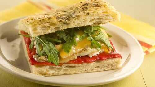 This twist on a pepper and egg sandwich has all the elements of the traditional version, but also adds olive tapenade, cheese and fresh arugula. (Bill Hogan/Chicago Tribune/TNS)