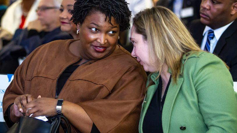 Stacey Abrams (L) talks with fellow Democrats during the 2019 Georgia Democratic Party State Convention in Atlanta GA January 26, 2019.  STEVE SCHAEFER / SPECIAL TO THE AJC