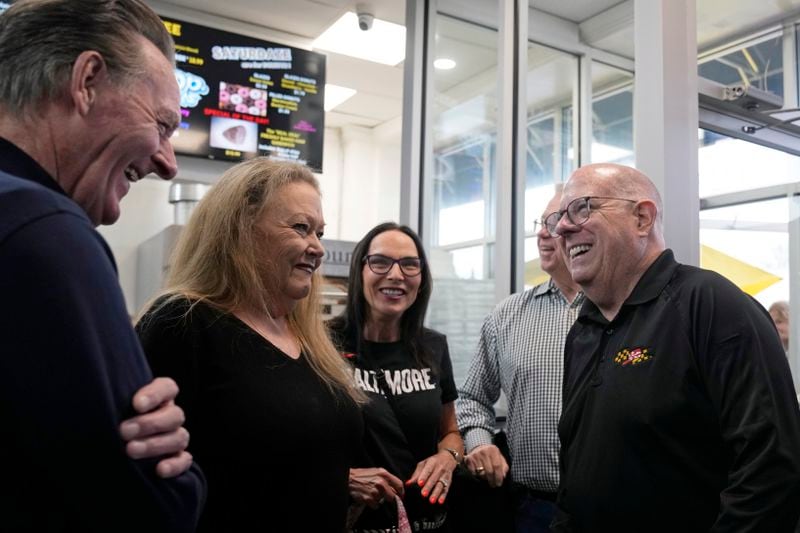 Former Maryland Gov. Larry Hogan, right, talks with patrons of DePaola's Bagel and Brunch in Stevensville, Md., Friday, April 12, 2024, as he campaigns for the U.S. Senate. (AP Photo/Susan Walsh)