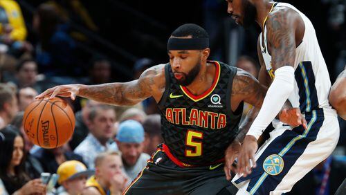 Atlanta Hawks guard Malcolm Delaney, left, works the ball inside as Denver Nuggets guard Will Barton defends in the first half of an NBA basketball game Wednesday, Jan. 10, 2018 in Denver. (AP Photo/David Zalubowski)