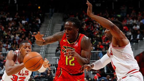 Kris Dunn of the Chicago Bulls attempts a steal as Taurean Prince of the Atlanta Hawks drives against David Nwaba at Philips Arena on March 11, 2018 in Atlanta, Georgia. (Photo by Kevin C. Cox/Getty Images)