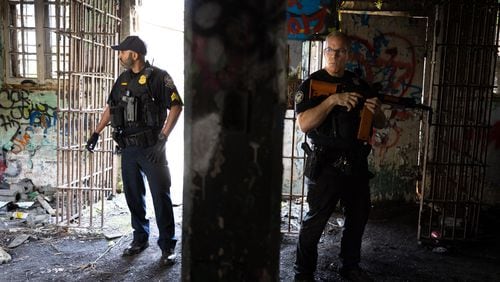 Officers stand in an old prison farm building during an Atlanta Police Department and Atlanta Fire Rescue media tour of the Atlanta Public Safety Training Center site on Friday, May 26, 2023. (Arvin Temkar / arvin.temkar@ajc.com)