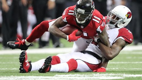 Falcons wide receiver Julio Jones makes a first down catch against Cardinals cornerback Patrick Peterson during the second quarter in an NFL football game on Sunday, Nov. 27, 2016, in Atlanta. Curtis Compton/ccompton@ajc.com