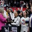 South Carolina head coach Dawn Staley, center, celebrates with the trophy after the Final Four college basketball championship game against Iowa in the women's NCAA Tournament, Sunday, April 7, 2024, in Cleveland. South Carolina won 87-75. (AP Photo/Morry Gash)
