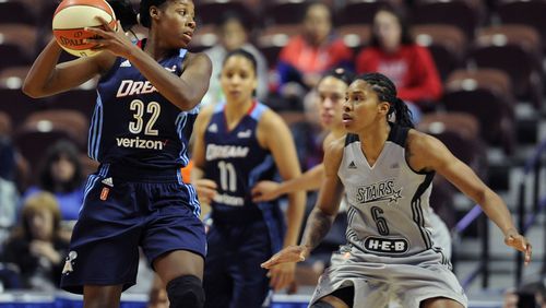 Bria Holmes of the Dream looks to pass around Alex Montgomery, right, of San Antonio during the second half of a WNBA basketball game, Wednesday, May 4, 2016, in Uncasville, Conn. (AP Photo/Jessica Hill)