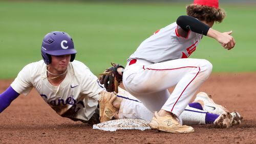 Cartersville infielder Andrew Purdy (21) steals second base ahead of the tag by Loganville infielder Brantley Carter (8) during the third inning in game three of the Class 5A GHSA baseball finals at Coolray Field, Friday, May 17, 2024, in Lawrenceville, Ga. (Jason Getz / AJC)
