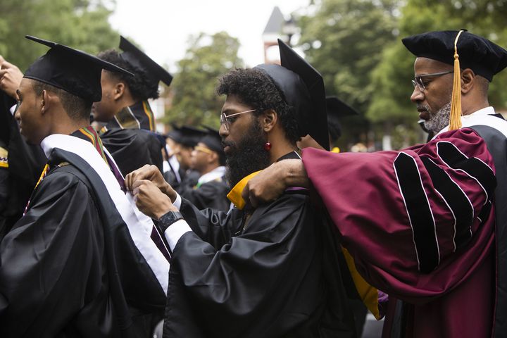 Members of the Morehouse College class of 2023 bestow stolls upon their peers during the Morehouse College commencement ceremony on Sunday, May 21, 2023, on Century Campus in Atlanta. The graduation marked Morehouse College's 139th commencement program. CHRISTINA MATACOTTA FOR THE ATLANTA JOURNAL-CONSTITUTION