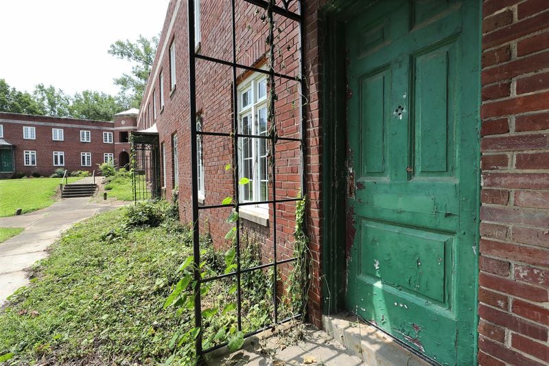 A boarded-up door on an empty brick building that was once part of Techwood Homes on Monday, Aug. 2, 2021, in Atlanta. Curtis Compton / Curtis.Compton@ajc.com