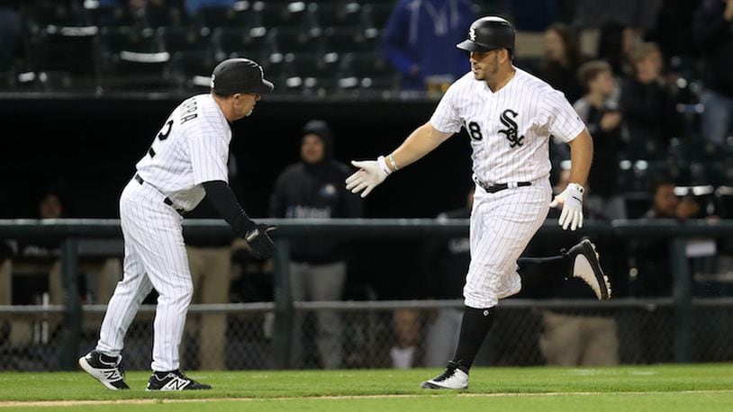 The Chicago White Sox' Daniel Palka (18) is congratulated by third base coach Nick Capra after Palka hit a two-run home run against the Minnesota Twins at Guaranteed Rate Field in Chicago on May 3, 2018. (Chris Sweda/Chicago Tribune/TNS)