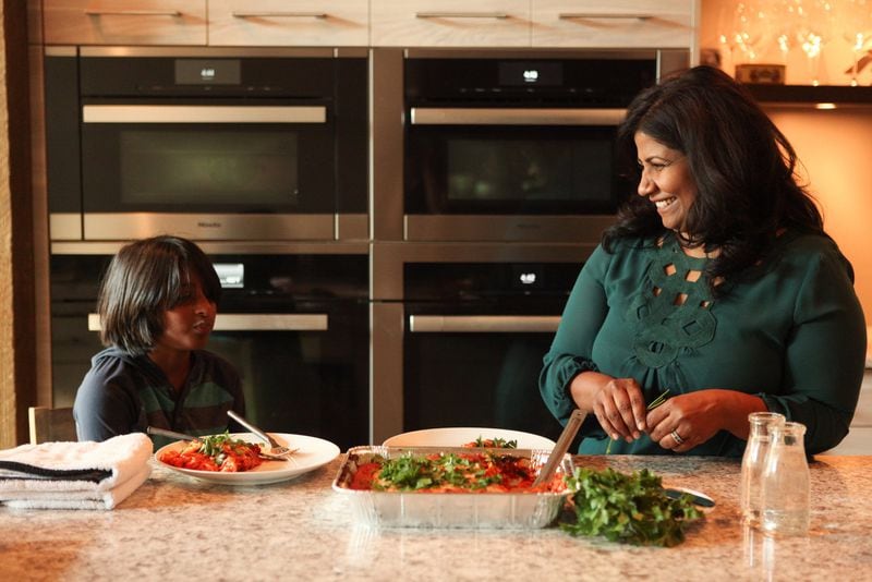 When Asha Gomez posted a photo of a Stouffer’s Lasagna box on Instagram, many moms recognized the packaging and replied, Gomez recalled, saying words to the effect of, “Thank you for allowing us not to feel like bad mommies.” The chef at Spice to Table and author of new cookbook “My Two Souths” also is the mother of an 11-year-old son. “I made real lasagna once, and he liked the Stouffer’s better,” Gomez said. (Renee Brock)