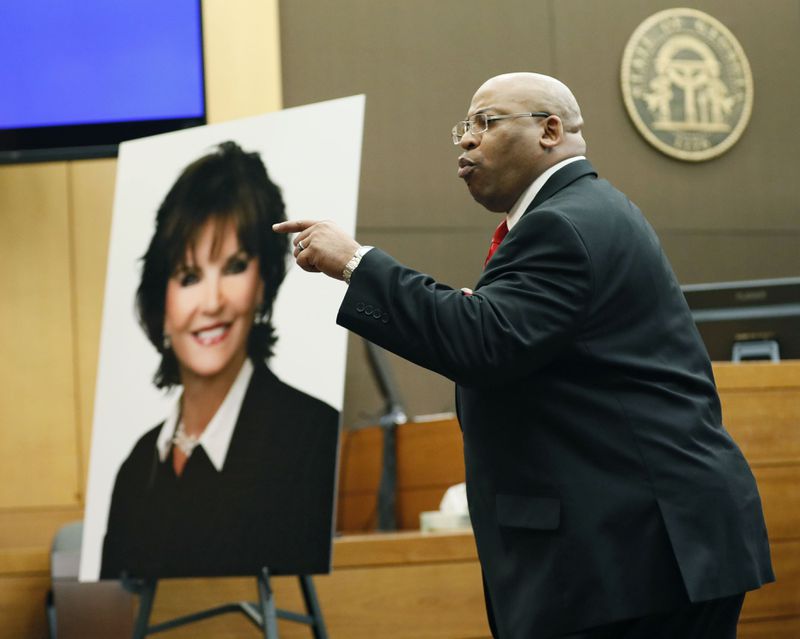 4/17/18 - Atlanta -  Chief Assistant District Attorney Clint Rucker, with a photo of Diane McIver behind him, makes closing arguments for the prosecution today during the Tex McIver murder trial at the Fulton County Courthouse.   Bob Andres bandres@ajc.com