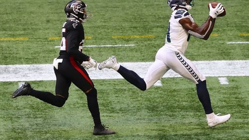091320 Atlanta: Seattle Seahawks wide receiver D.K. Metcalf catches a touchdown pass past Atlanta Falcons cornerback Isaiah Oliver for a 21- 12 lead during the third quarter Sunday, Sept. 13, 2020, in Atlanta.  (Curtis Compton / Curtis.Compton@ajc.com)