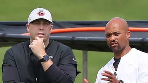 Falcons head coach Arthur Smith (left) and general manager Terry Fontenot confer during team practice at minicamp Wednesday, June 10, 2021, in Flowery Branch. (Curtis Compton / Curtis.Compton@ajc.com)