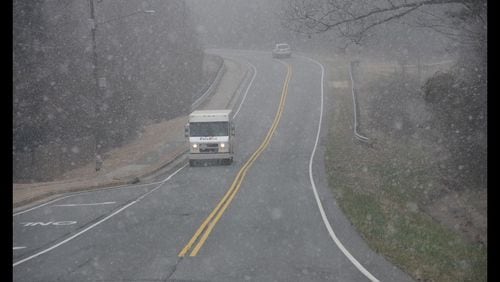 Flurries on Tues., Feb. 9, 2016, did not stop people from hitting walking and running trails in Snellville in Gwinnett County. HYOSUB SHIN / HSHIN@AJC.COM