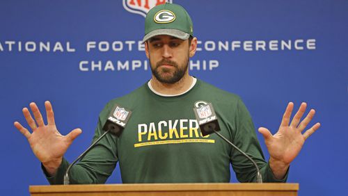 Green Bay Packers quarterback Aaron Rodgers has been dealing with the flu but says he’ll be fine Sunday when it comes time to play the Falcons. (AP Photo/Matt Ludtke)