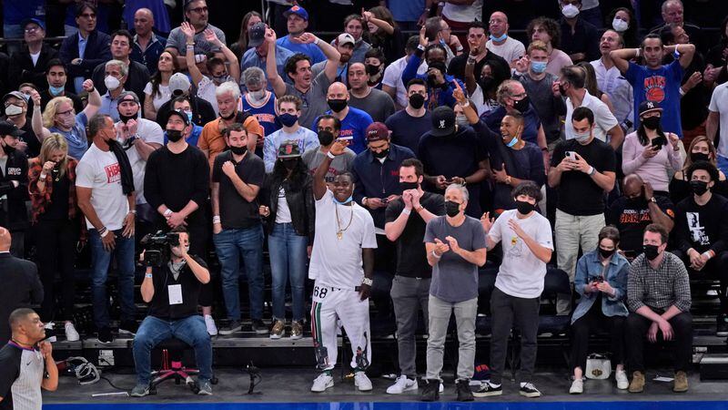 Knicks fans - including actor Tracy Morgan (bottom, center) - rise to their feet as the Knicks gained the lead near the closing minutes of Game 1 of the first-round playoff series against the Atlanta Hawks, Sunday, May 23, 2021, in New York. The Hawks' Trae Young scored with 0.9 seconds left to give Atlanta a 107-105 win. (Seth Wenig/AP)