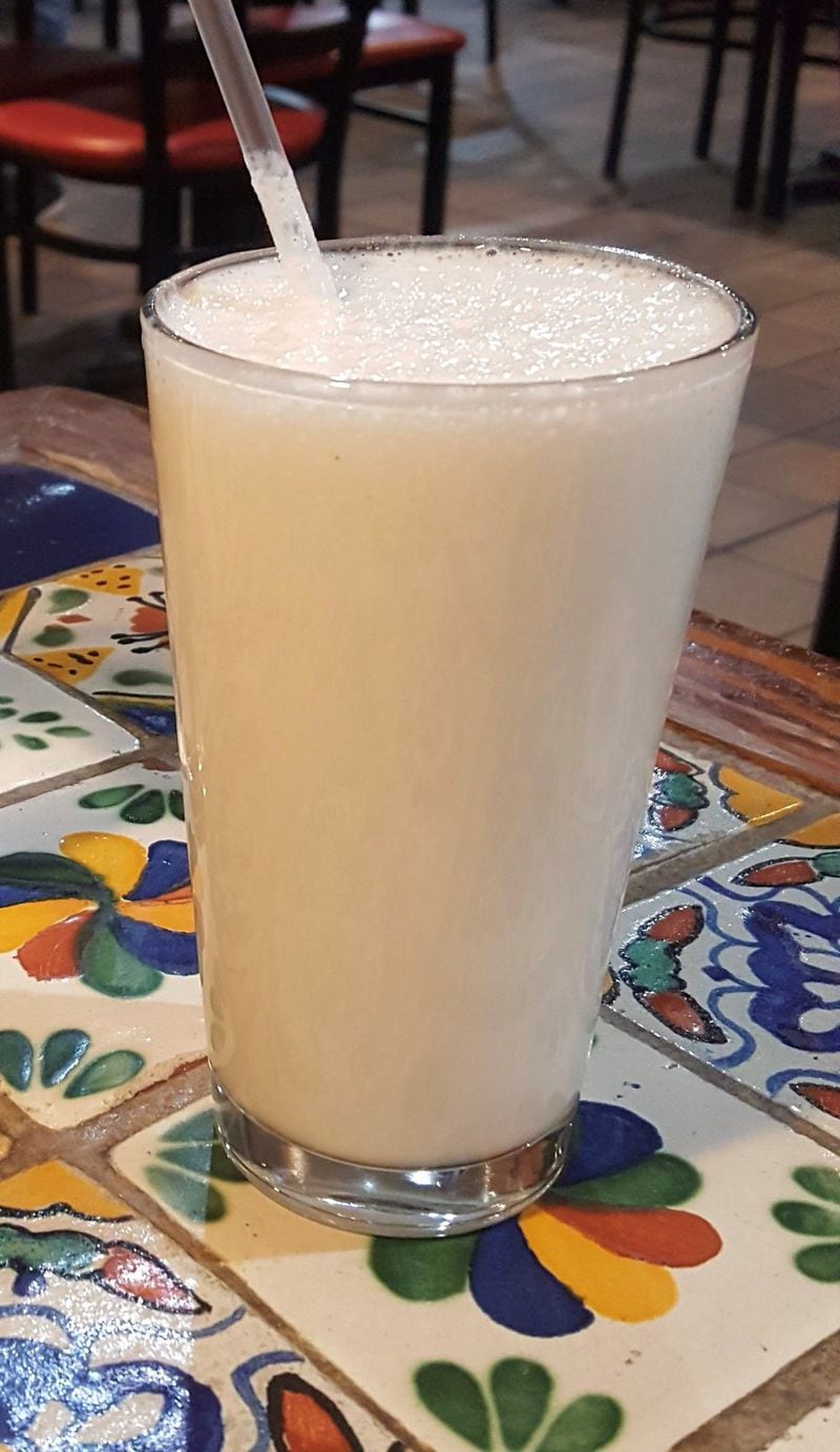 Jugo natural con leche at Casa Vieja tastes like a light, frothy milkshake. Pictured is one made with soursop, or guanabana. LIGAYA FIGUERAS / LFIGUERAS@AJC.COM