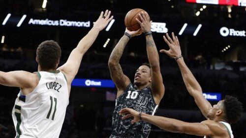 DeMar DeRozan (10) shoots against Milwaukee during Sunday's game. DeRozan scored 28 points to lead San Antonio to a 121-114 victory.